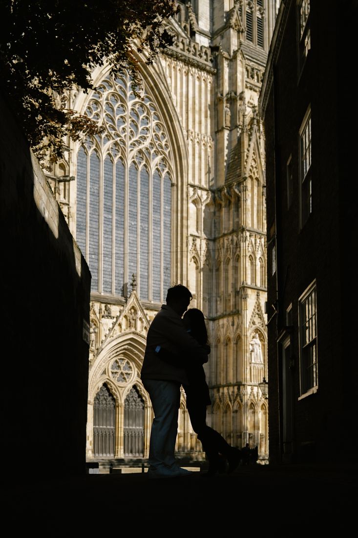 Couple silhouetted in an alley facing York Minster