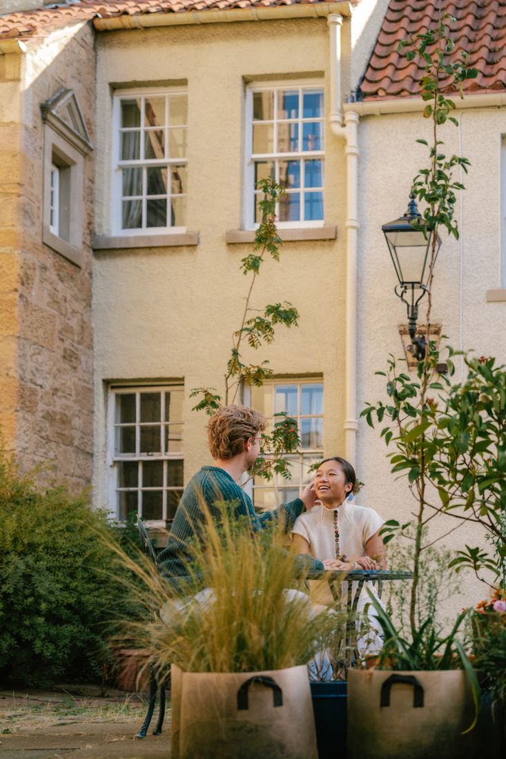 Couple in a sunny courtyard garden