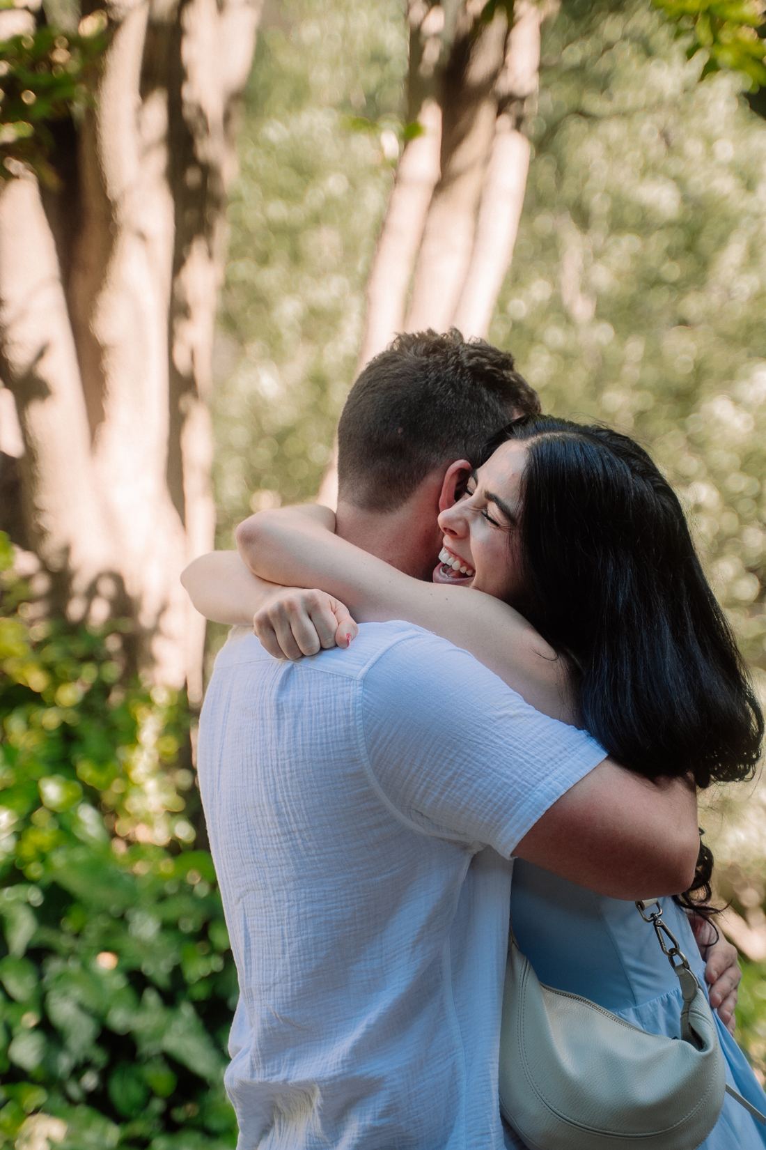Woman laughing as she hugs her new fiancé
