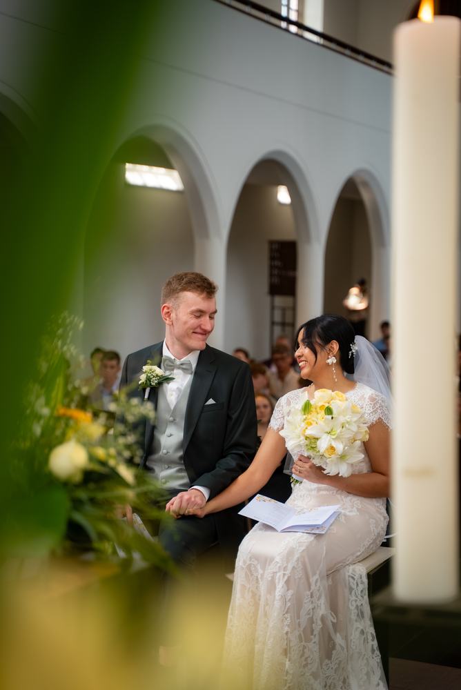 Bride and groom smiling at each other during the ceremony