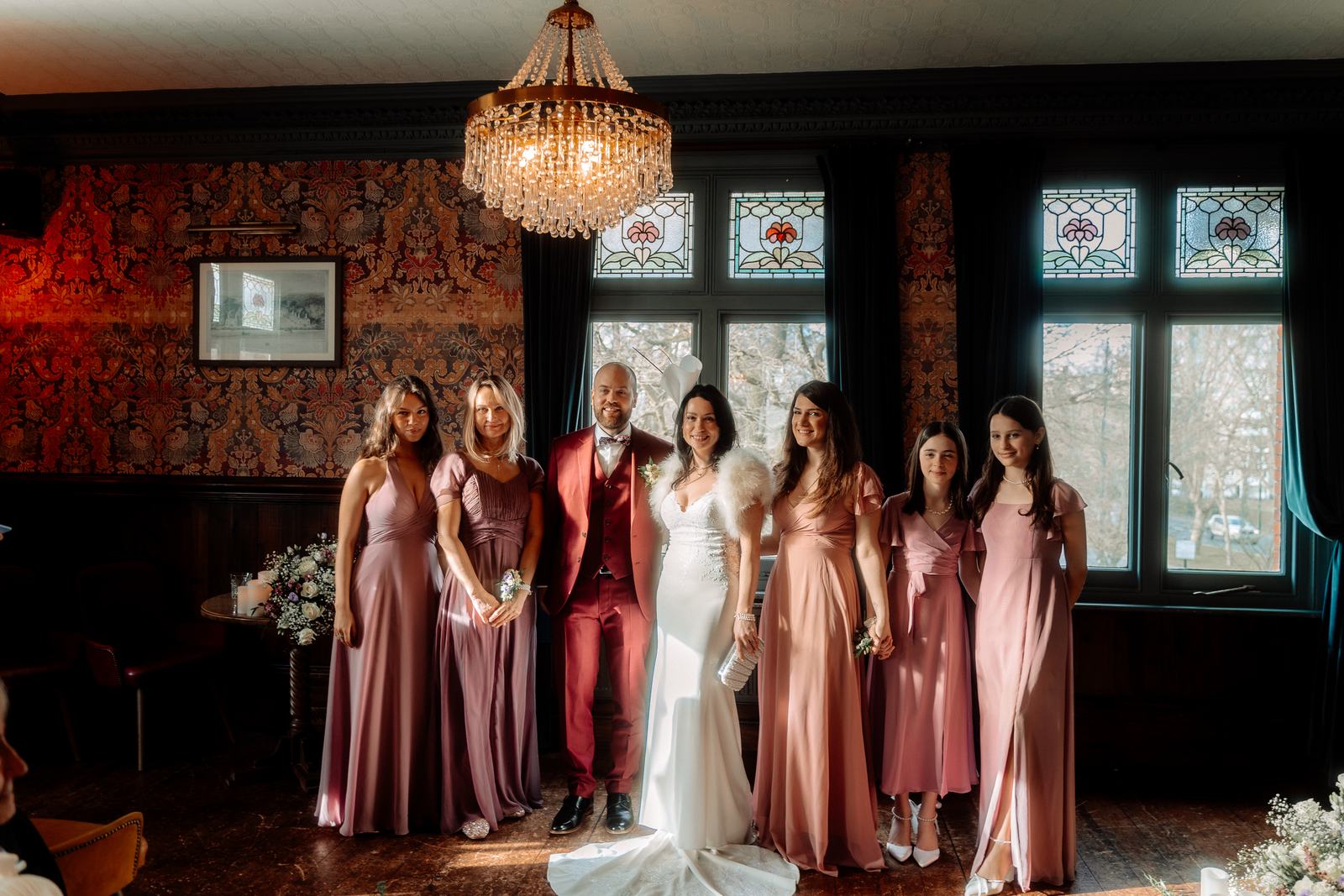 Bride and groom with the bridesmaids in pink