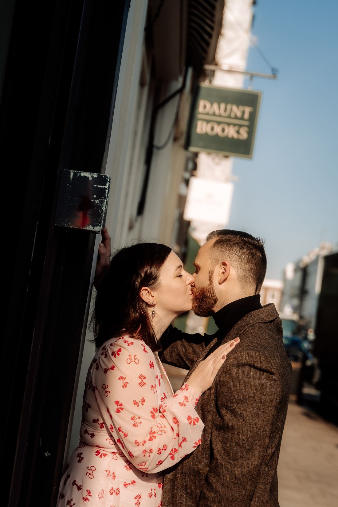 Couple kissing beside the Daunt Books sign