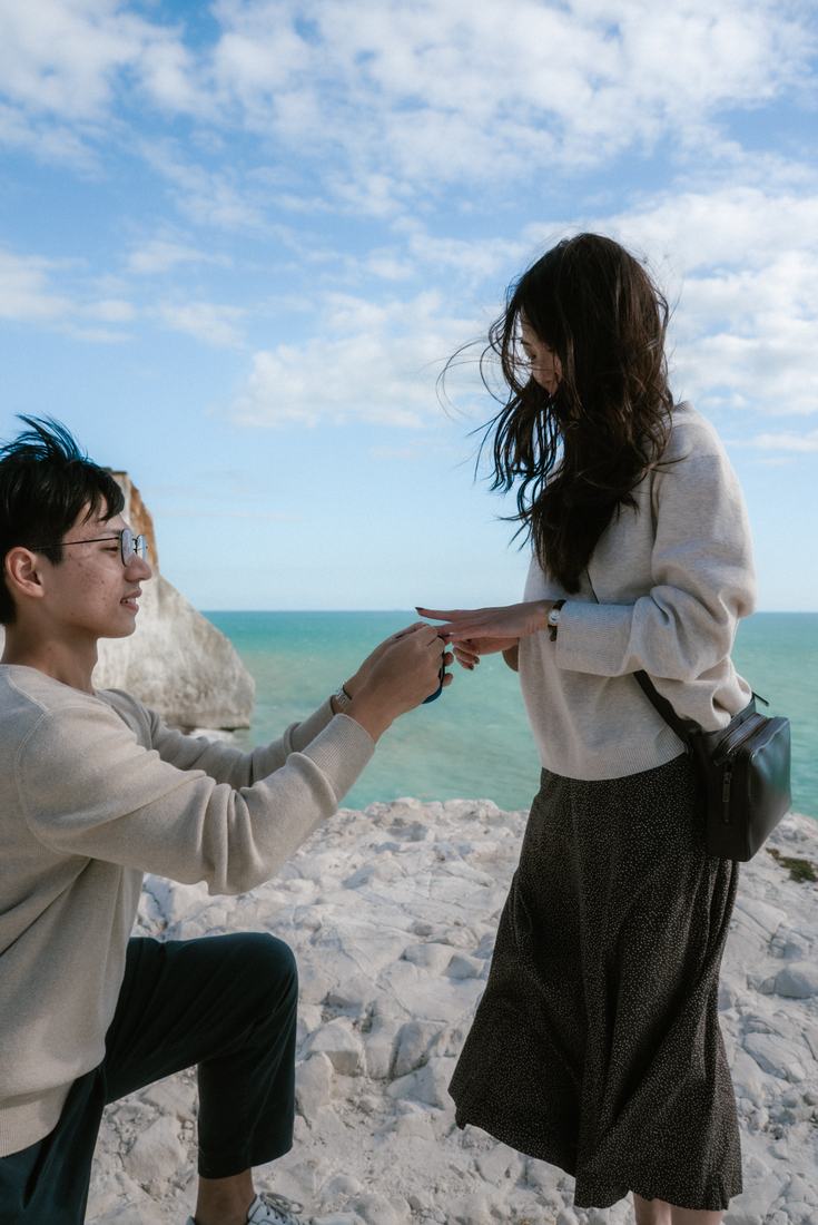 Man on one knee holding out a ring