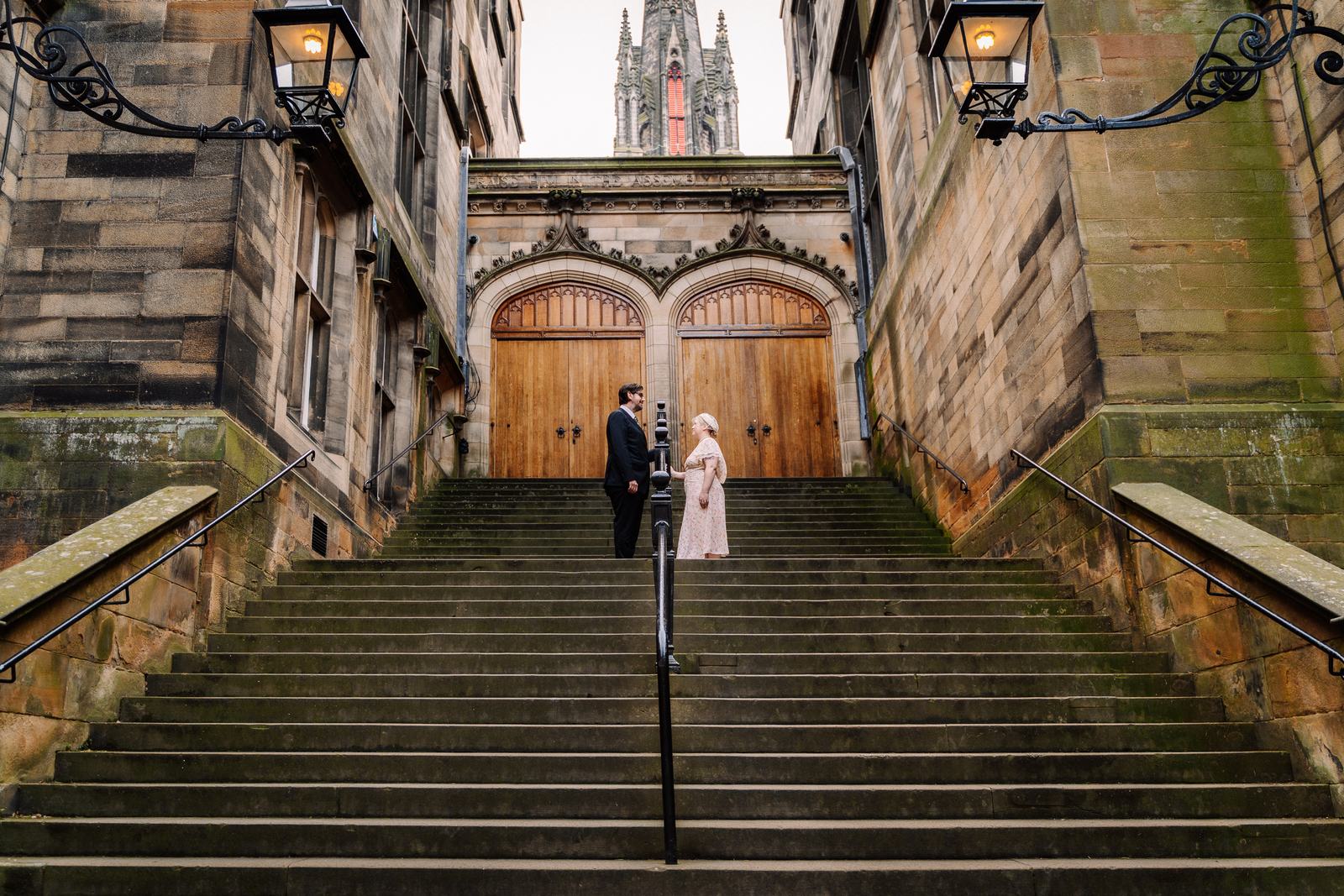 Couple on grand stone steps in Edinburgh Old Town