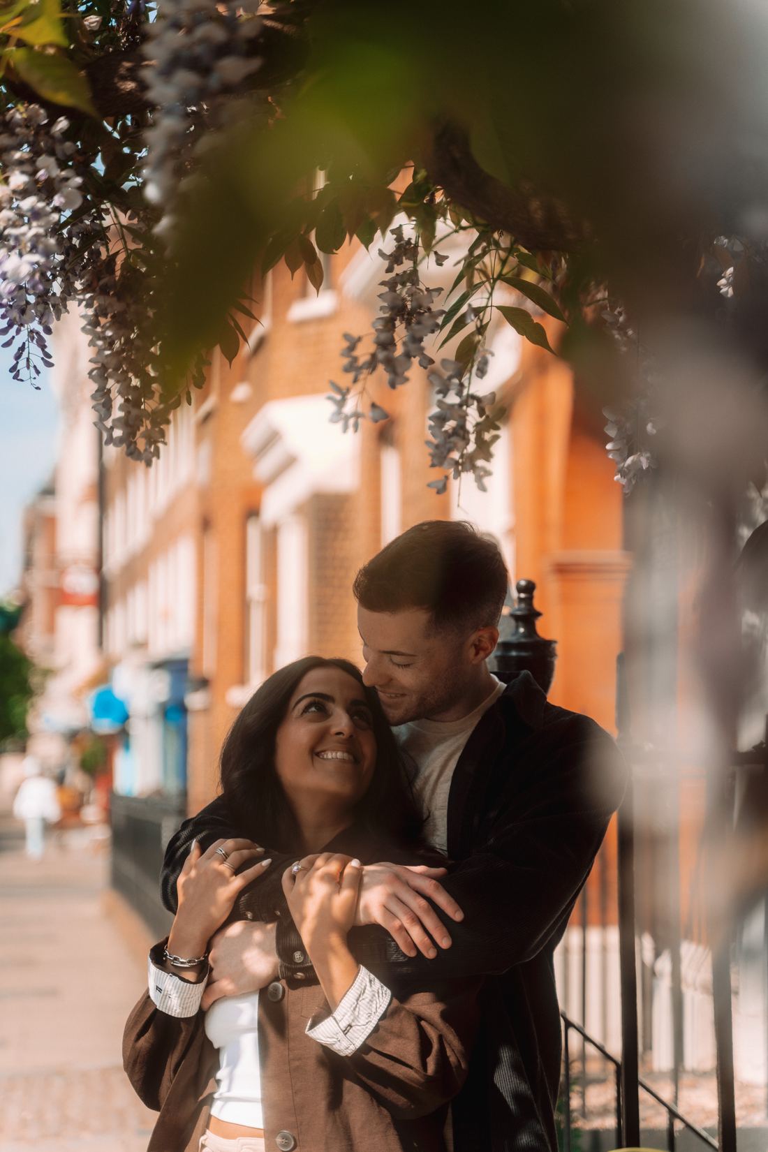 Couple embracing under wisteria